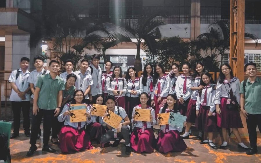 St. Mark students gathered on campus holding certificates after an awards ceremony.